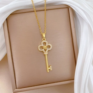 Macro shot of gold starburst cross key pendant with sparkling zircons on jewelry pad