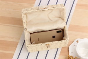 Detail view of woven box bag interior with space for a smartphone and metal lock