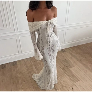 Close-up of elegant white lace off-shoulder dress with intricate floral embroidery details