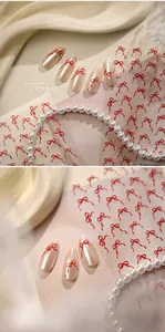 Détail d'autocollants pour ongles nœud rouge avec texture 3D sur ongles nacrés