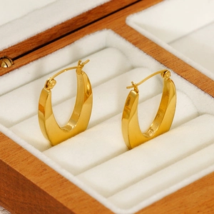 Polished 18k gold-plated stainless steel hoop earrings in a wooden velvet jewelry box