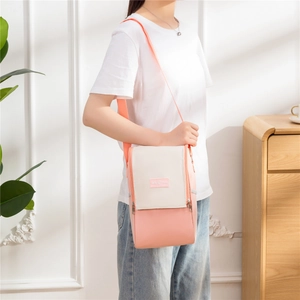 Pink and beige insulated lunch bag with shoulder strap and Tasty Food label