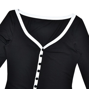 Detail of V-neck collar with white piping and single-breasted black buttons on dress