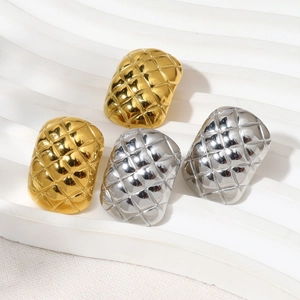 Detailed view of four oval rings with lattice pattern in gold and silver finish