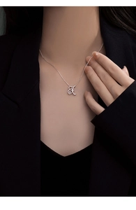 Close-up of elegant 925 silver letter K pendant necklace with a sparkling zircon stone