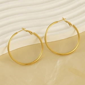 Detail of 18K gold-plated hoop earrings featuring a smooth finish and lever-back clasp