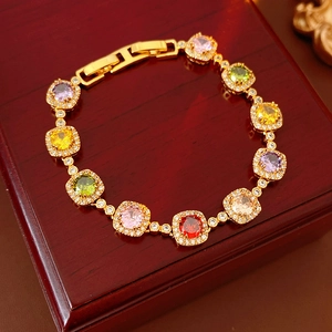 Macro detail of vintage gold bracelet with colorful square zircon stones and fold-over clasp
