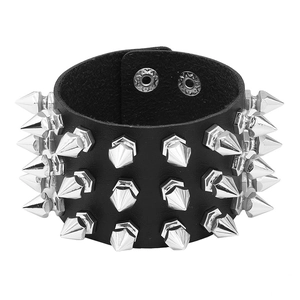 Punk leather bracelet with silver metal spikes and adjustable snap buttons on white background