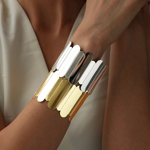 Detail of bicolor geometric stacked metal cuff bracelet with gold and silver finish