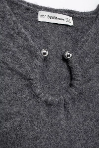 Detail of grey knitted dress neckline with metal buttons and BBWMWOMAN size label