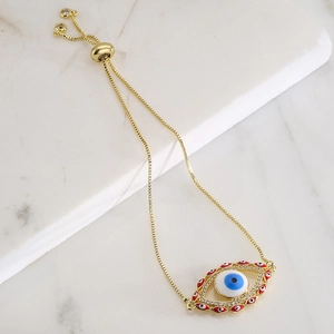 Bohemian evil eye bracelet with gold plating and sparkling zircon on marble tray