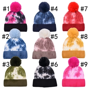 Women's autumn winter tie-dye beanie hats collection with fluffy faux fur pom-poms