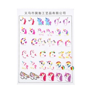 Close-up of 18 pairs unicorn earring set with colorful resin designs on a white display card