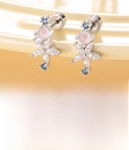 Macro shot of screw back flower earring with white zircon petals and pink center stone