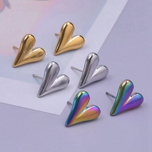 Detailed set of three heart-shaped stainless steel earrings in gold, silver, and rainbow colors