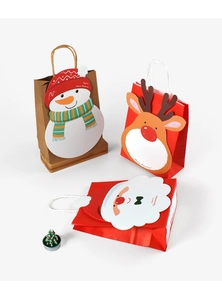 Three 3D Christmas gift bags featuring Santa, reindeer, and snowman designs with paper handles