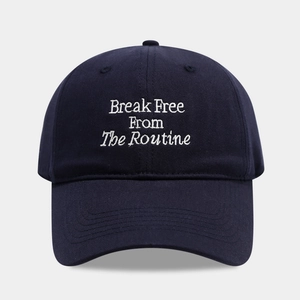 Macro shot of navy cotton baseball cap featuring white letter embroidery on a curved brim
