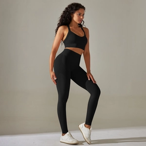 Detail of seamless black high-waist yoga leggings and crop top sports set texture