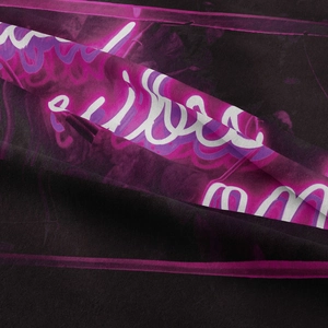 Macro view of high-density synthetic fabric with purple neon text on black tapestry