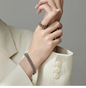 Detailed view of multilayer beaded stainless steel bracelet set with gold finish
