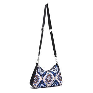 Detail of bohemian shoulder bag with blue geometric print, metal chain and wide strap