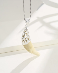 Macro shot of S925 sterling silver hollow cap on a canine tooth pendant necklace