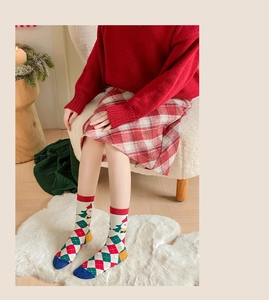 Detail of Christmas crew socks with festive reindeer patterns and holiday knit texture