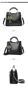 Detail view of the black retro handbag showing the leather texture and brand logo