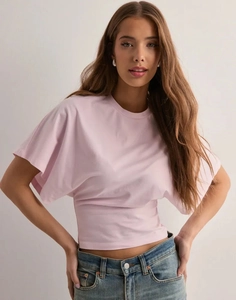 Dettaglio della t-shirt rosa a girocollo con maniche corte e un taglio aderente in vita