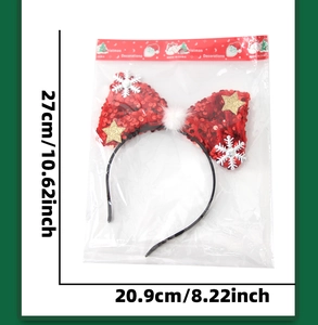 Detailed view of red sequin bow headband with snowflakes and stars in retail packaging