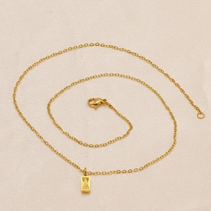Close-up of 18K gold-plated O-chain with rectangular yellow birthstone pendant