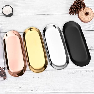 Oval stainless steel candle trays in rose gold, gold, silver, and matte black finishes