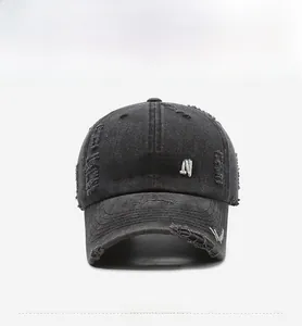 Detail of BOSTON 3D embroidery and distressed ripped texture on washed denim baseball cap