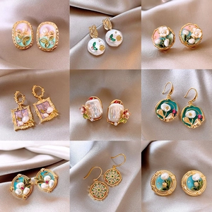Collection of nine floral freshwater pearl earrings in gold and silver plated metal