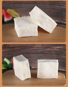 Close-up of realistic PVC tofu food model with detailed grid texture on wood tray