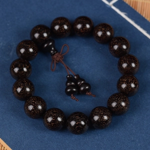 Dark Sandalwood Buddhist beads bracelet with gourd pendant on zen style background