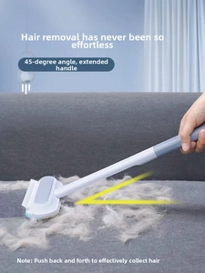 Detail of handheld pet hair remover with long handle and 45-degree tilting brush head
