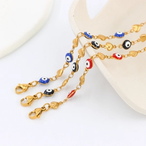 Golden heart link bracelets with colorful evil eye charms in blue, black, and red
