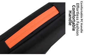 Close-up of durable orange PU leather handle on a sleek black fabric laptop sleeve