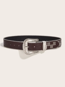 Close-up of brown crocodile pattern belt with crystal buckle and silver rivets