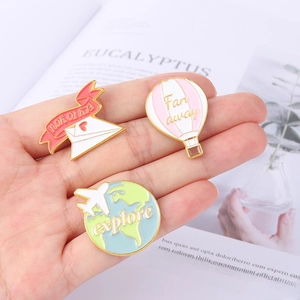 Set of travel themed alloy enamel pins featuring a hot air balloon, airplane and envelope