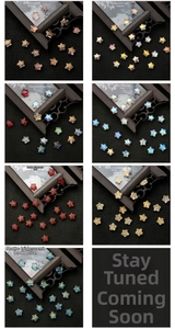 Macro view of colorful star-shaped glass beads with frosted and plated finishes