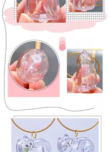 Detailed view of cat-shaped clear hair storage charm with gold chain and bottom plug