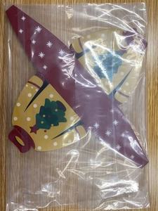 Close-up of red and yellow Christmas sweater pattern paper gift boxes in packaging