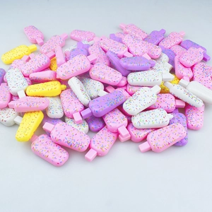 Macro shot of colorful resin mini ice cream charms with decorative candy sprinkles