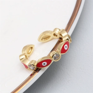 Macro view of gold evil eye ring featuring micro-pave zircons and enamel drip details