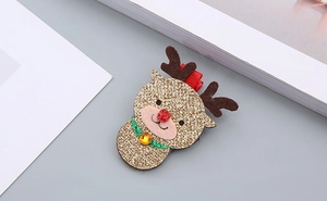 Détail d'une pince à cheveux renne de Noël pailletée avec bois et nœud rouge