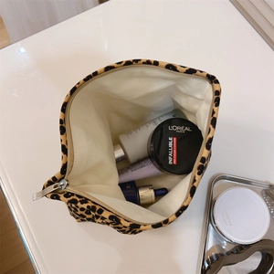 Detail view of leopard print canvas makeup bag showing interior storage capacity