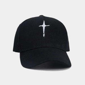 Close-up of high-quality white cross embroidery on a black cotton twill baseball cap