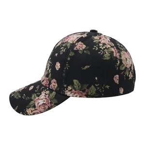 Side view detail of black baseball cap with vintage pink and tan floral patterns